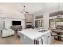 Open concept kitchen with island, living room, and fireplace views at 16268 S 12Th Pl, Phoenix, AZ 85048