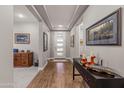 Bright entryway with hardwood floors and built-in shelving at 16925 W Virginia Ave, Goodyear, AZ 85395