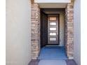 Modern front door entry with stone accents at 16925 W Virginia Ave, Goodyear, AZ 85395