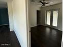 Bright bedroom with dark hardwood floors and access to a patio at 217 W Fairhaven W Rd, Kearny, AZ 85137