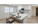 Modern kitchen with white cabinets, a large island, and stainless steel appliances at 2328 E Laurel Ln, Phoenix, AZ 85028