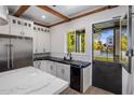 Modern kitchen with black and white finishes and a pool view at 3322 N Valencia Ln, Phoenix, AZ 85018