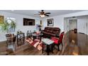 Spacious living room with hardwood floors, a leather couch, and large TV at 4122 S 185Th Ln, Goodyear, AZ 85338