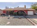 Red brick ranch house with a landscaped front yard and a two-car garage at 6433 W Cortez St, Glendale, AZ 85304