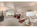 Living room with golf course view and comfy seating at 10020 N 109Th Ave, Sun City, AZ 85351