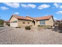 Attractive single-story home with a well-manicured yard featuring desert landscaping and a red tile roof at 10626 E Voax Dr, Sun Lakes, AZ 85248