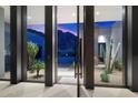 Glass entry with mountain views and desert landscaping at 11952 E Casitas Del Rio Dr, Scottsdale, AZ 85255