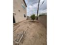 Small backyard with dirt and a small tree at 12321 W Florence St, Avondale, AZ 85323