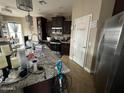 Spacious kitchen with dark wood cabinets and granite countertops at 12321 W Florence St, Avondale, AZ 85323