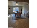 Bright dining area with a wood table and chairs, tiled floors and a view to backyard at 12411 N Cantata Ct, Sun City, AZ 85351