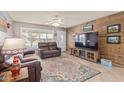 Living room with leather furniture and wood accent wall at 12411 N Cantata Ct, Sun City, AZ 85351