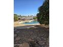 Inviting kidney-shaped pool with surrounding rock landscaping and patio at 12411 N Cantata Ct, Sun City, AZ 85351