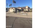 Single story house with a two-car garage and mature landscaping at 1354 E Brentrup Dr, Tempe, AZ 85283