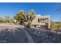 This home features attractive desert landscaping and a unique architectural design at 17022 E Player Ct, Fountain Hills, AZ 85268