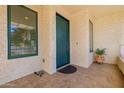 A teal front door welcomes visitors to this home's entrance at 17022 E Player Ct, Fountain Hills, AZ 85268