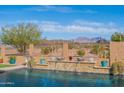 Sparkling pool with water features and desert views at 17844 E Pacana Ct, Gold Canyon, AZ 85118