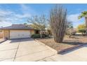 House exterior with a garage and desert landscaping at 1801 E Aire Libre Ave, Phoenix, AZ 85022