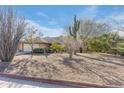 Single-story home with desert landscaping and a two-car garage at 1801 E Aire Libre Ave, Phoenix, AZ 85022