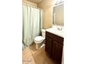 Clean bathroom with shower/tub combo, toilet, and vanity with dark wood cabinets at 1914 N Lebaron --, Mesa, AZ 85201