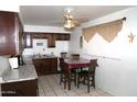 Cozy kitchen features dark wood cabinets and a breakfast nook at 1914 N Lebaron --, Mesa, AZ 85201