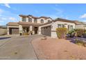 Two-story house with a three-car garage and landscaping at 19646 E Reins Rd, Queen Creek, AZ 85142