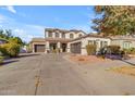 Two-story house with a three-car garage and landscaping at 19646 E Reins Rd, Queen Creek, AZ 85142