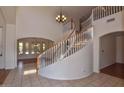 Elegant entryway with a curved staircase and chandelier at 22830 N 32Nd Ln, Phoenix, AZ 85027