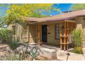 Brick home with a covered porch and mature trees at 2434 E Pinchot Ave, Phoenix, AZ 85016