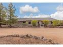 Ranch style home with rock wall accents and mature landscaping at 313 W Saddle Mountain Rd, Phoenix, AZ 85086