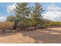 Ranch style home with rock wall accents and mature landscaping at 313 W Saddle Mountain Rd, Phoenix, AZ 85086