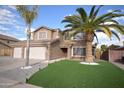 Charming two-story home with a three car garage, well-manicured lawn and palm tree at 31689 N Blackfoot Dr, San Tan Valley, AZ 85143