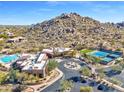 Community clubhouse with pool, tennis courts, and mountain backdrop at 33108 N 72Nd Way, Scottsdale, AZ 85266