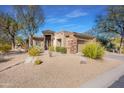 Single-story home with desert landscaping and stone accents at 33108 N 72Nd Way, Scottsdale, AZ 85266