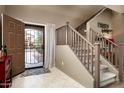 Entryway with staircase, tiled floors, and a view into the living area at 33610 N 26Th Ave, Phoenix, AZ 85085