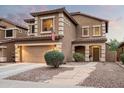 Two-story house with tan exterior, landscaped yard, and a two-car garage at 33610 N 26Th Ave, Phoenix, AZ 85085