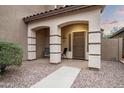 Covered front porch with two chairs and a walkway leading to the front door at 33610 N 26Th Ave, Phoenix, AZ 85085