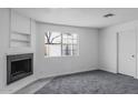 Living room with a fireplace and built-in shelving at 3426 W Elm St, Phoenix, AZ 85017