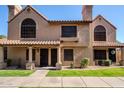 Two-story stucco condo with Spanish tile roof, walkway, and grassy yard at 3491 N Arizona Ave # 54, Chandler, AZ 85225