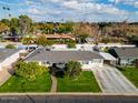 An aerial view showcasing a charming single-story home with a well-manicured lawn and driveway at 3601 N 48Th Way, Phoenix, AZ 85018