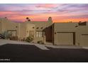 Tan stucco home with a two-car garage and desert landscaping at 37222 N Tom Darlington Dr # 2, Carefree, AZ 85377