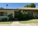 Brick home with gray door and lush landscaping at 4800 N 68Th St # 349, Scottsdale, AZ 85251