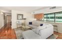 Bright living room featuring hardwood floors, sectional sofa, and city views at 4808 N 24Th St # 921, Phoenix, AZ 85016