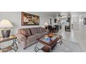 Living room with sofa and coffee table, open to kitchen and dining area at 540 S West Rd # 12, Wickenburg, AZ 85390