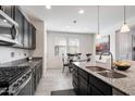 Modern kitchen featuring dark cabinetry and granite countertops at 5704 E Butte St, Mesa, AZ 85205