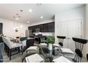 Kitchen with an island, dining area, and dark cabinetry at 5704 E Butte St, Mesa, AZ 85205