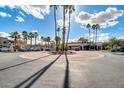 Attractive community entrance with palm trees and circular drive at 5757 W Eugie Ave # 2078, Glendale, AZ 85304