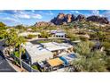 Aerial view of single-story home with desert landscaping, mountain backdrop, and circular driveway at 5818 N 45Th St, Phoenix, AZ 85018