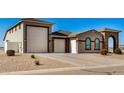 Single-story home with a large garage and landscaped front yard at 6608 N Cima Vista Dr, Casa Grande, AZ 85194