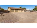 Exterior view of a single-story home with a driveway and landscaping at 7118 E Arbor Ave, Mesa, AZ 85208