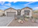 Single-story home with gray garage door and brick accents at 8043 E Jaeger St, Mesa, AZ 85207